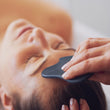 Load image into Gallery viewer, Gua Sha facial massage on woman's forehead
