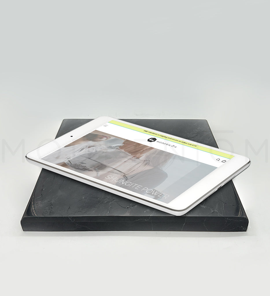 Tablet charging on a black plate