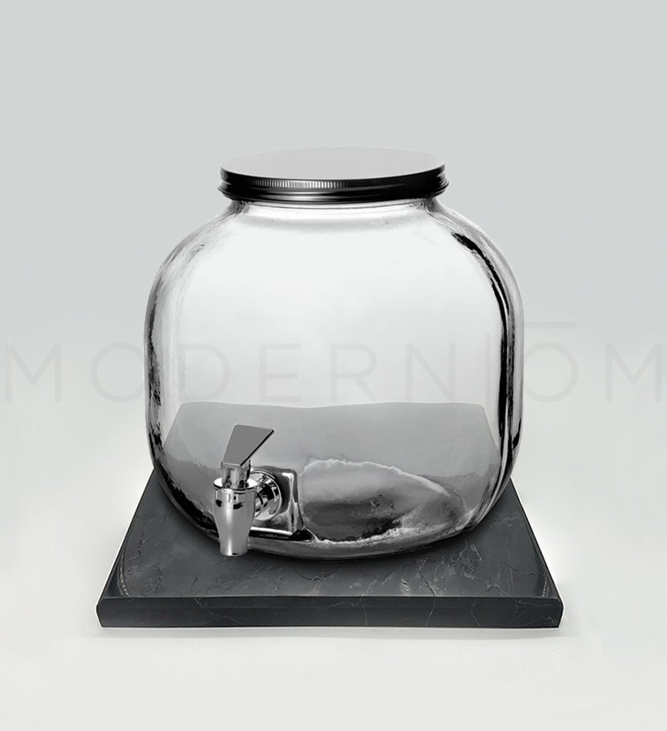 Glass beverage dispenser on black charging plate