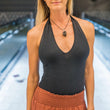 Load image into Gallery viewer, Woman in black halter top and brown pants, jazshieldweb