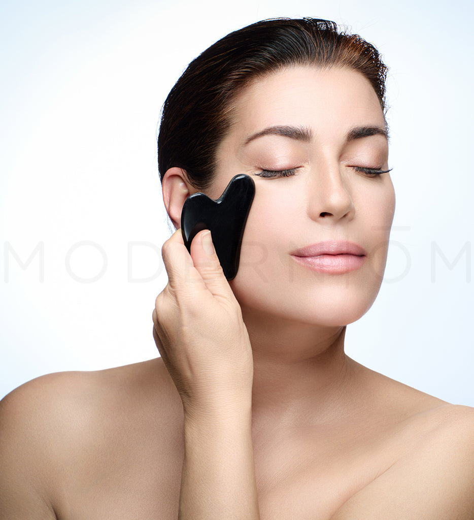Gua Sha facial massage with black stone