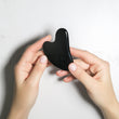 Load image into Gallery viewer, Black Gua Sha tool held in hands