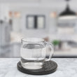Load image into Gallery viewer, Shgnt Disk with glass of water on a black coaster