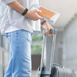 Load image into Gallery viewer, Traveler with passport and suitcase