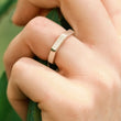 Load image into Gallery viewer, Silver ring on a finger.