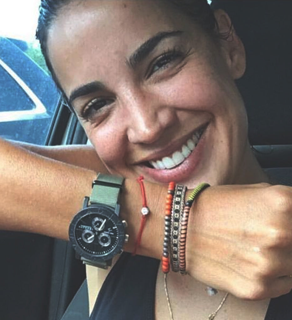 happy customer wearing modern om red string bracelet