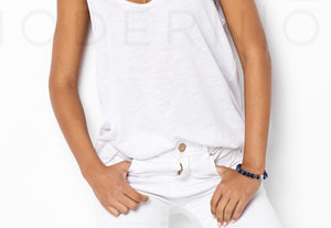 Woman wearing sapphire bracelet and white outfit