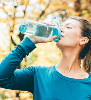 Woman drinking water from bottle - Web Visual A